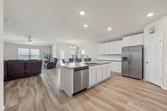 a kitchen with sink cabinets and wooden floor