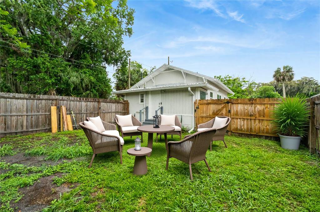 1416 6th Street St. Cloud, FL 34769 - Photo 12 of 13 a view of a house with backyard sitting area and garden
