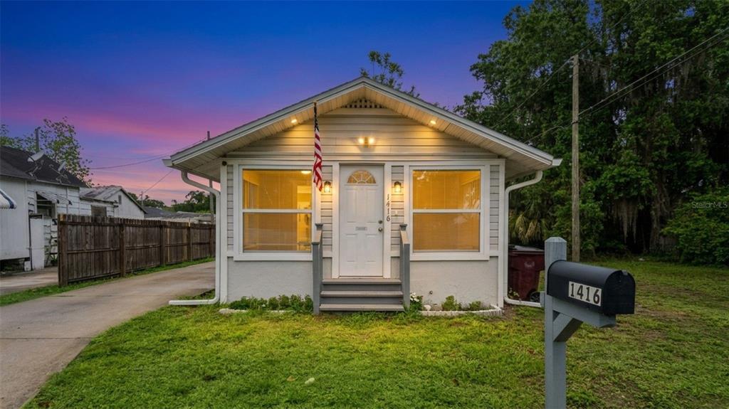 1416 6th Street St. Cloud, FL 34769 - Photo 2 of 13 a front view of a house with a garden