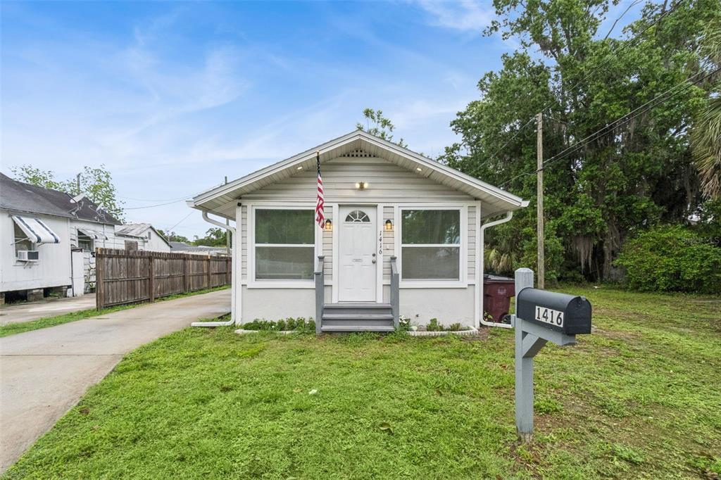 1416 6th Street St. Cloud, FL 34769 - Photo 3 of 13 a front view of house with yard and green space