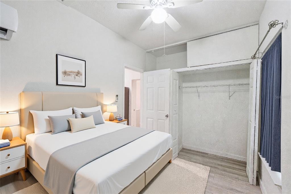 1416 6th Street St. Cloud, FL 34769 - Photo 8 of 13 a bedroom with a large bed and a chandelier