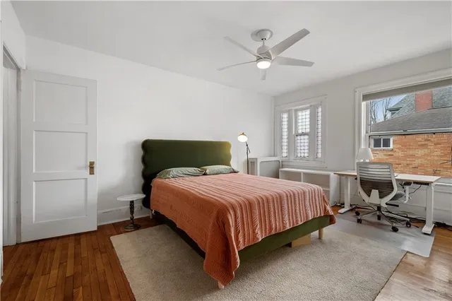 a bedroom with a bed and a table in it with window