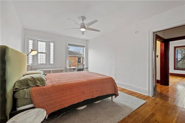 a bedroom with a bed couch and window