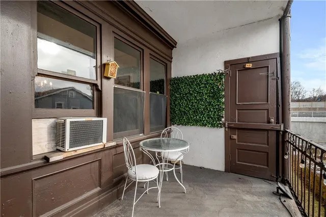 a kitchen with stainless steel appliances granite countertop a refrigerator and a chair