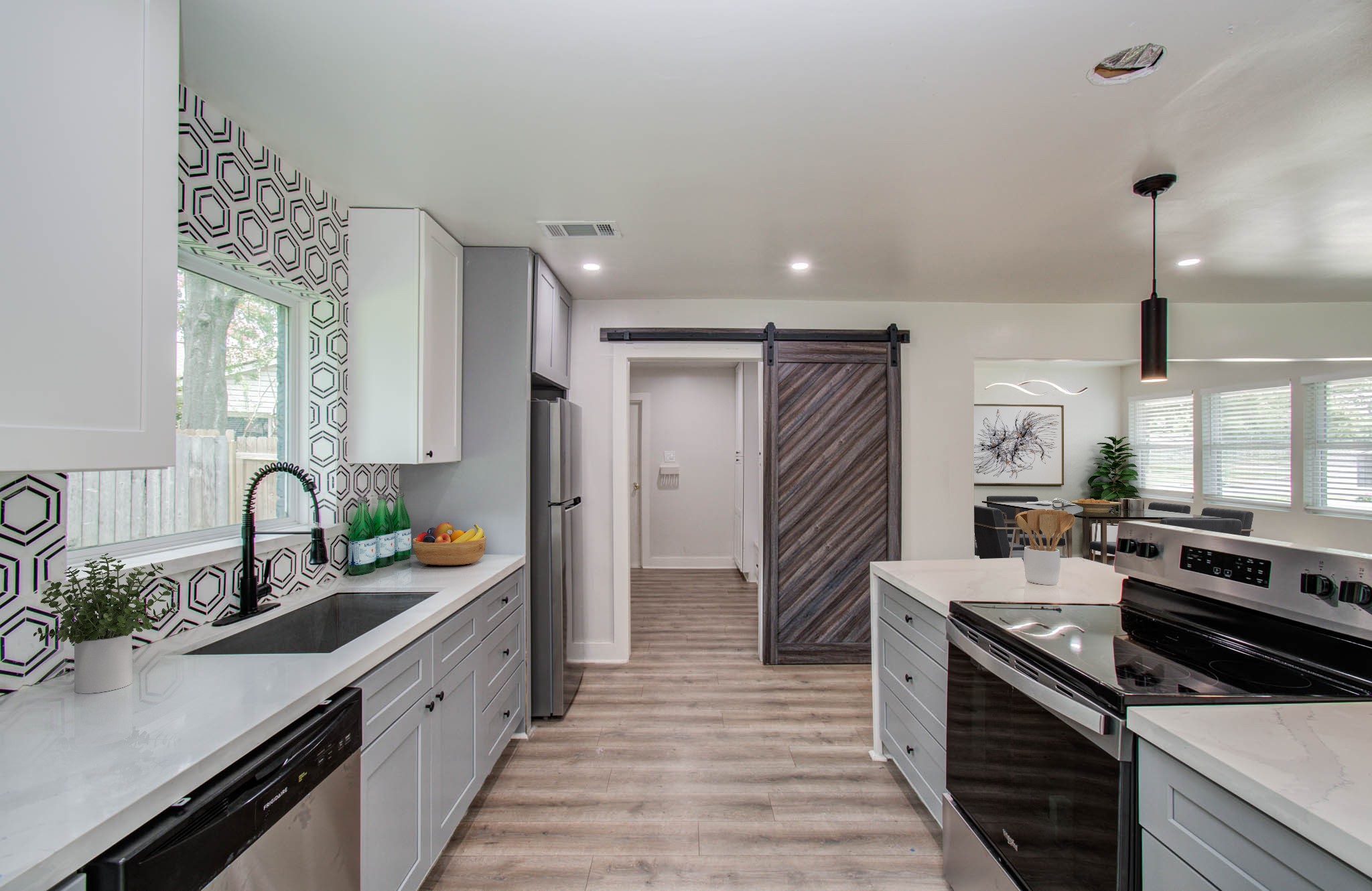 10415 Westray Street Houston, TX 77043 - Photo 11 of 45 a kitchen with stainless steel appliances a sink stove and cabinets