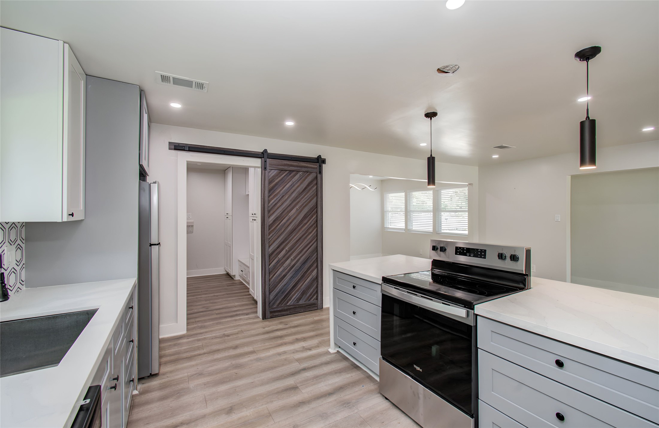 10415 Westray Street Houston, TX 77043 - Photo 13 of 45 a kitchen with a stove and a refrigerator