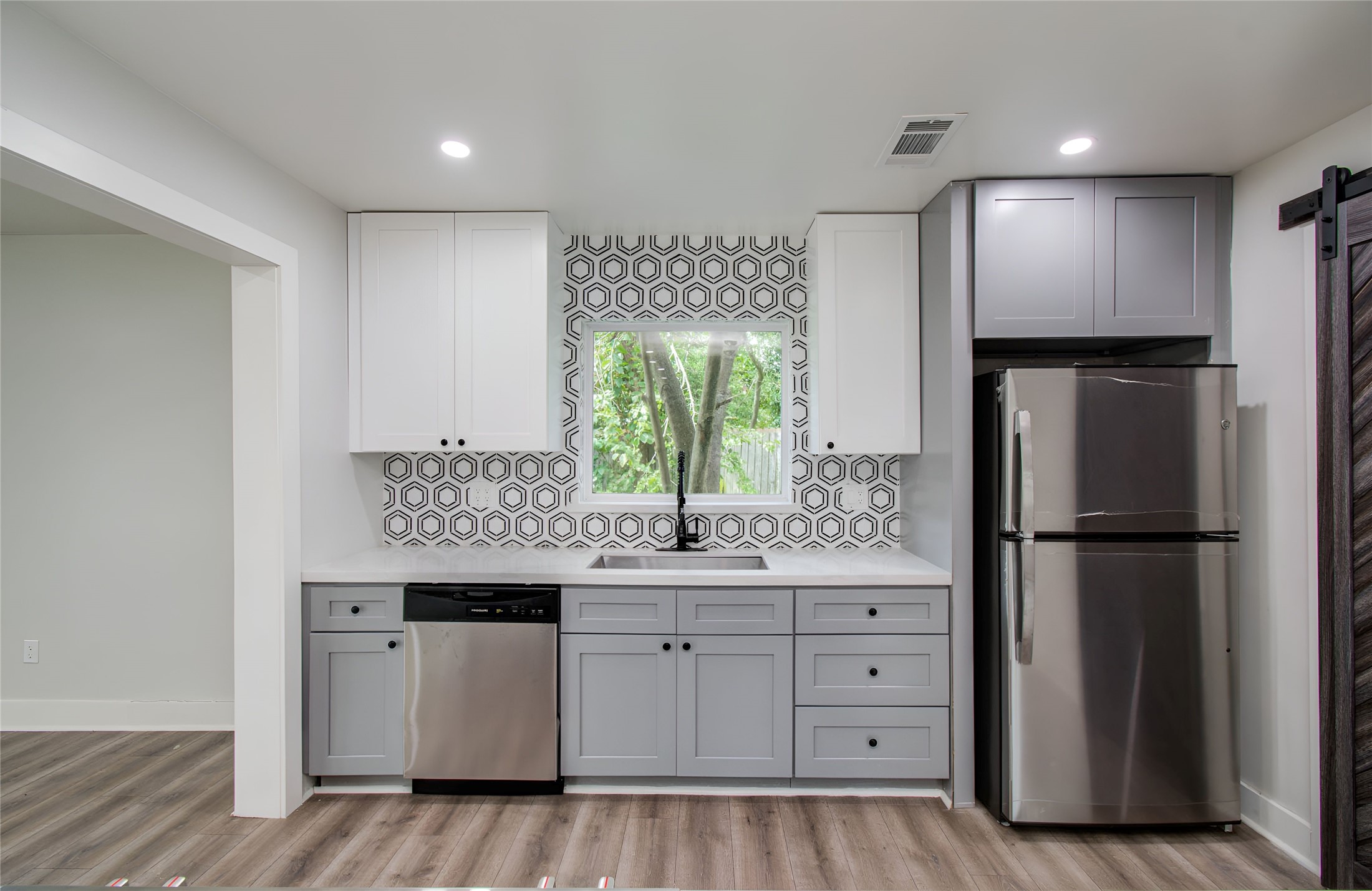 10415 Westray Street Houston, TX 77043 - Photo 18 of 45 a kitchen with a refrigerator and a sink