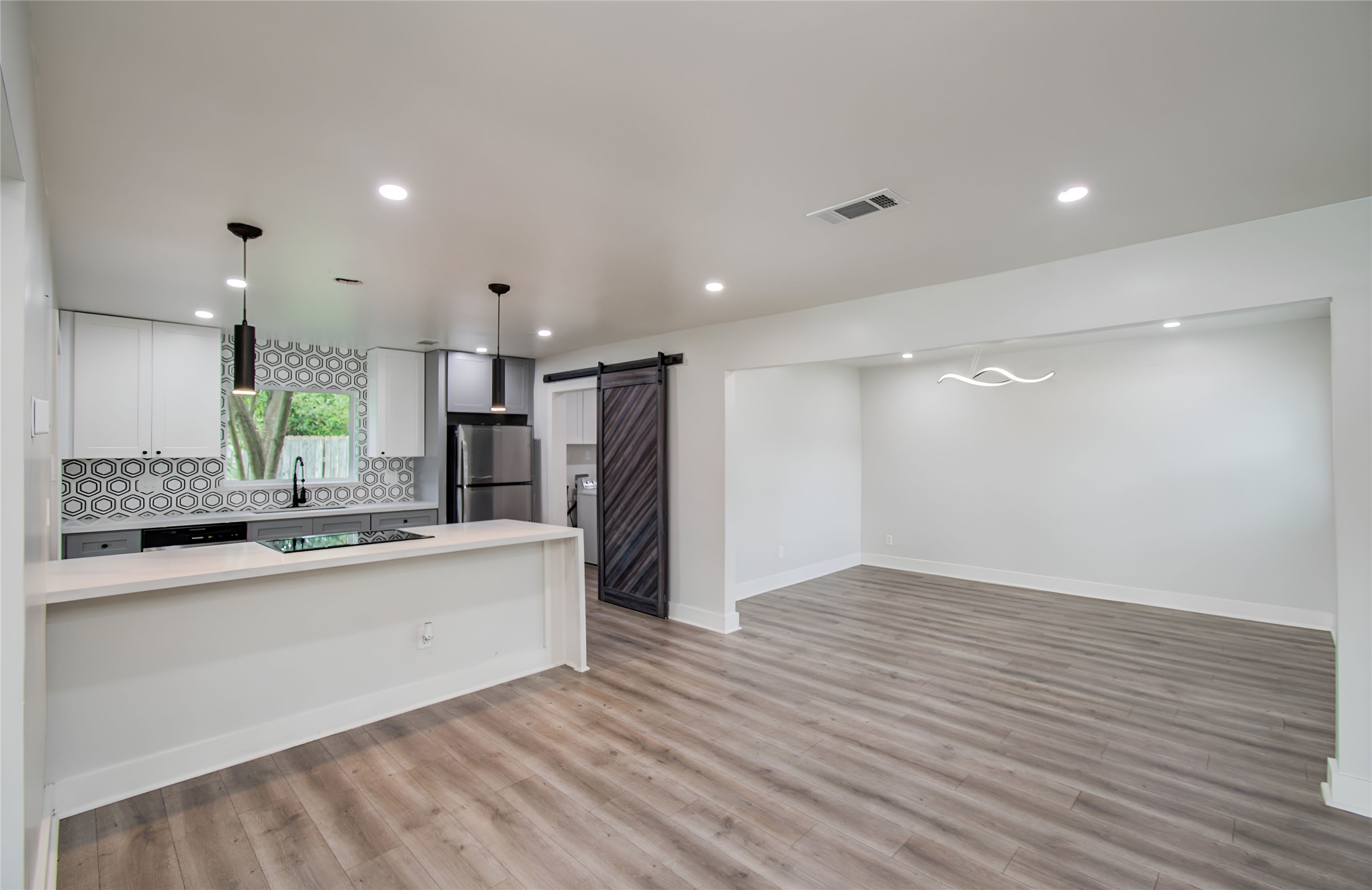 10415 Westray Street Houston, TX 77043 - Photo 19 of 45 a large kitchen with stainless steel appliances a large counter top a sink and a refrigerator