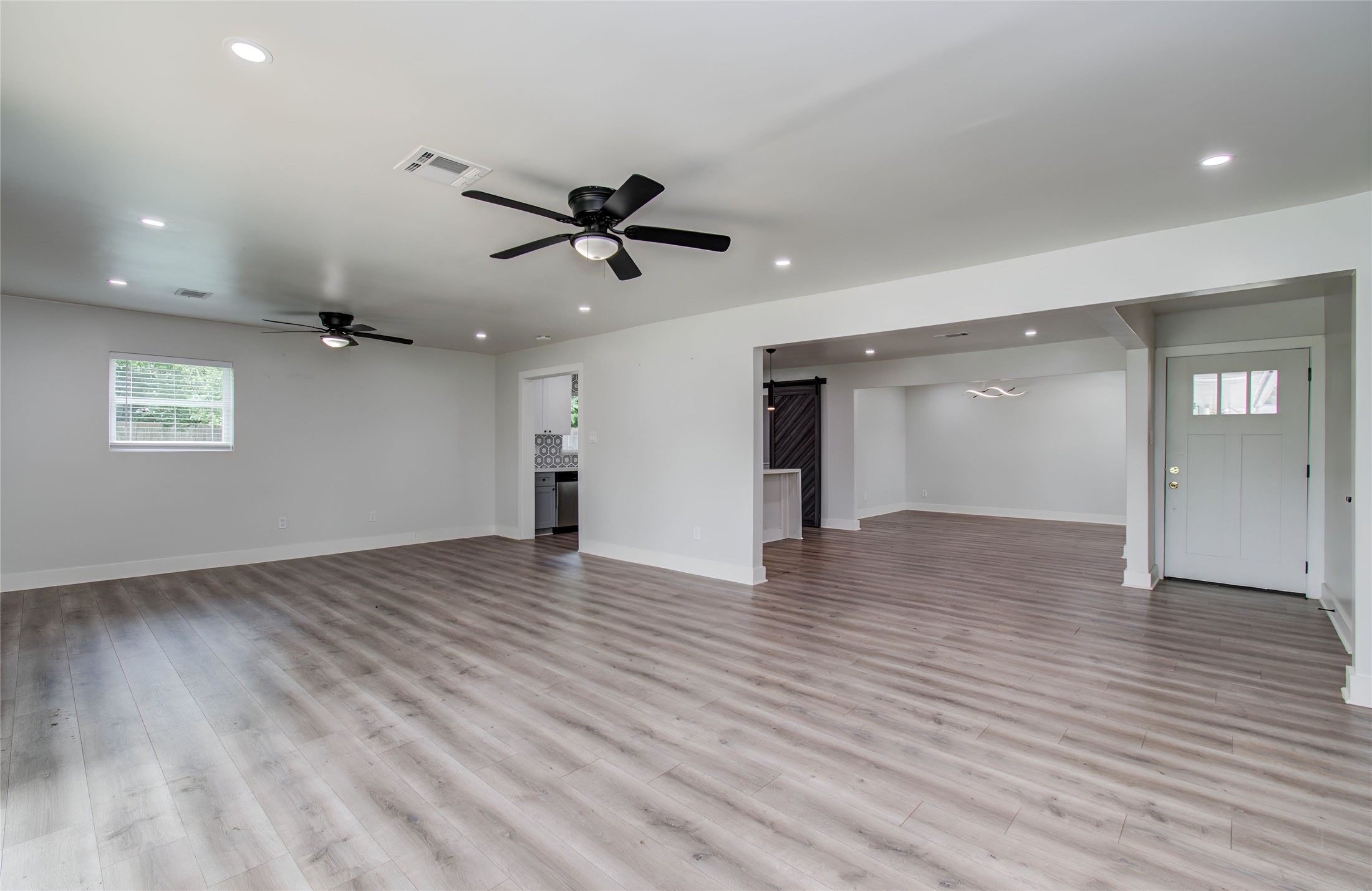 10415 Westray Street Houston, TX 77043 - Photo 24 of 45 a view of empty room with wooden floor and ceiling fan