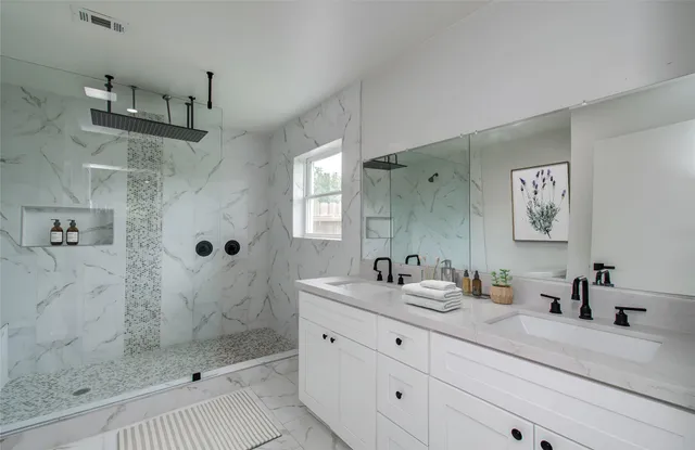 a bathroom with a shower sink and mirror