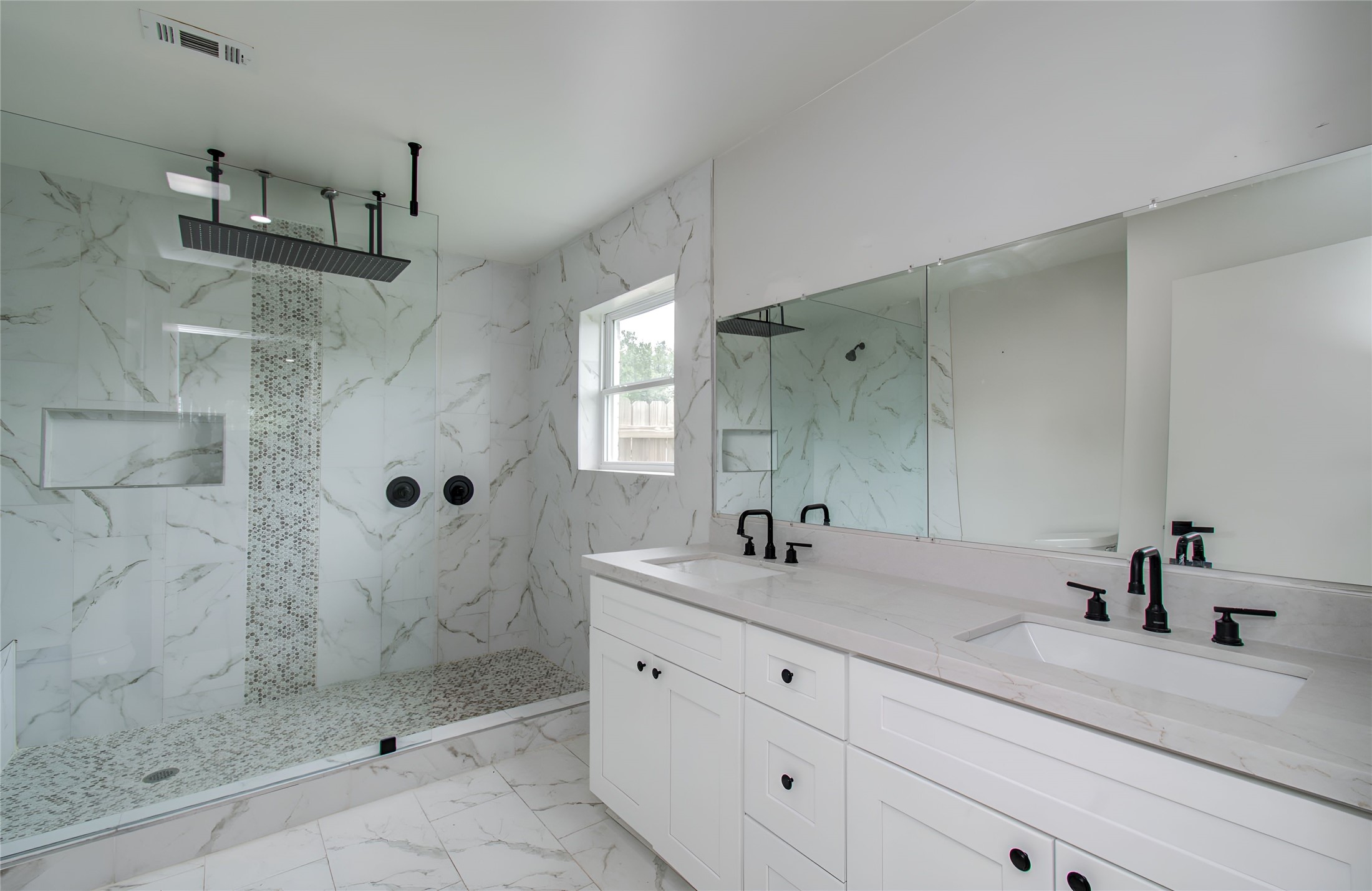 10415 Westray Street Houston, TX 77043 - Photo 40 of 45 a bathroom with a shower sink and mirror