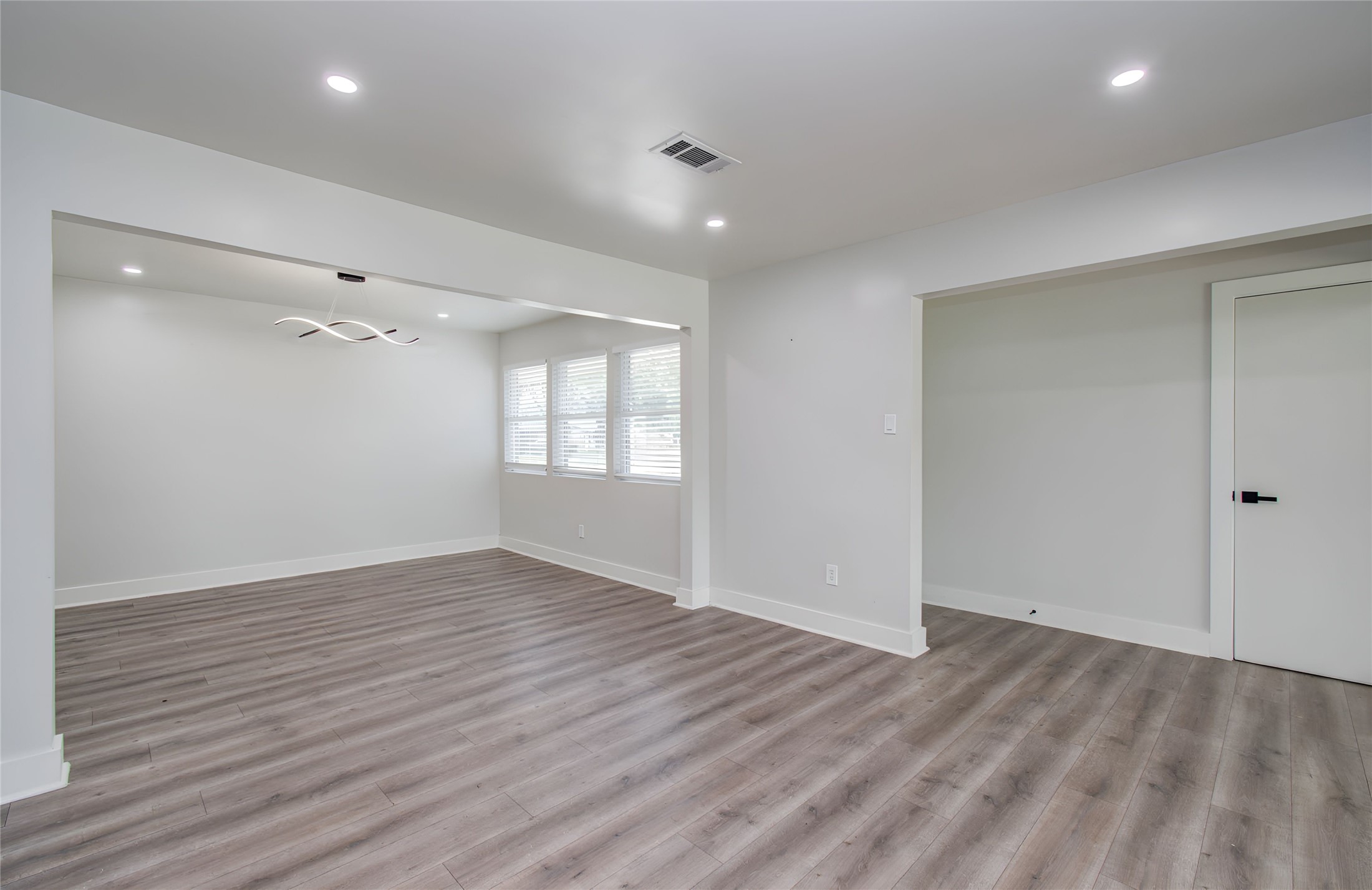 10415 Westray Street Houston, TX 77043 - Photo 5 of 45 wooden floor in an empty room with a window