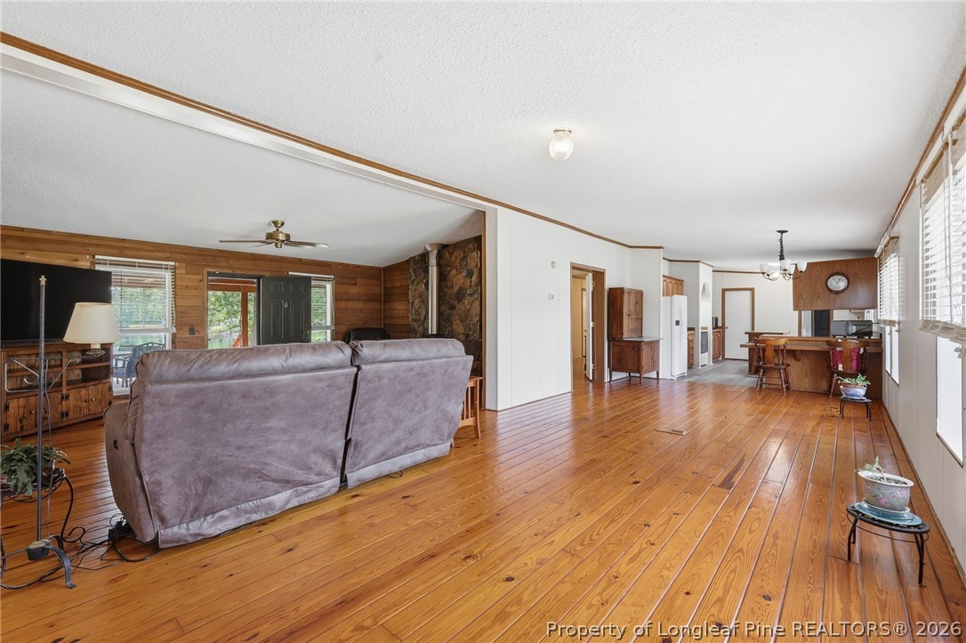 10400 Ruth Vinson Road Autryville, NC 28318 - Photo 25 of 49 a living room with furniture and a wooden floor