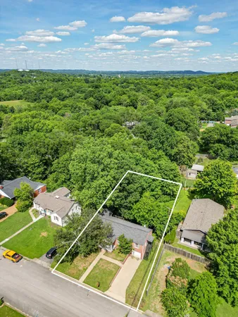 an aerial view of a houses with a yard