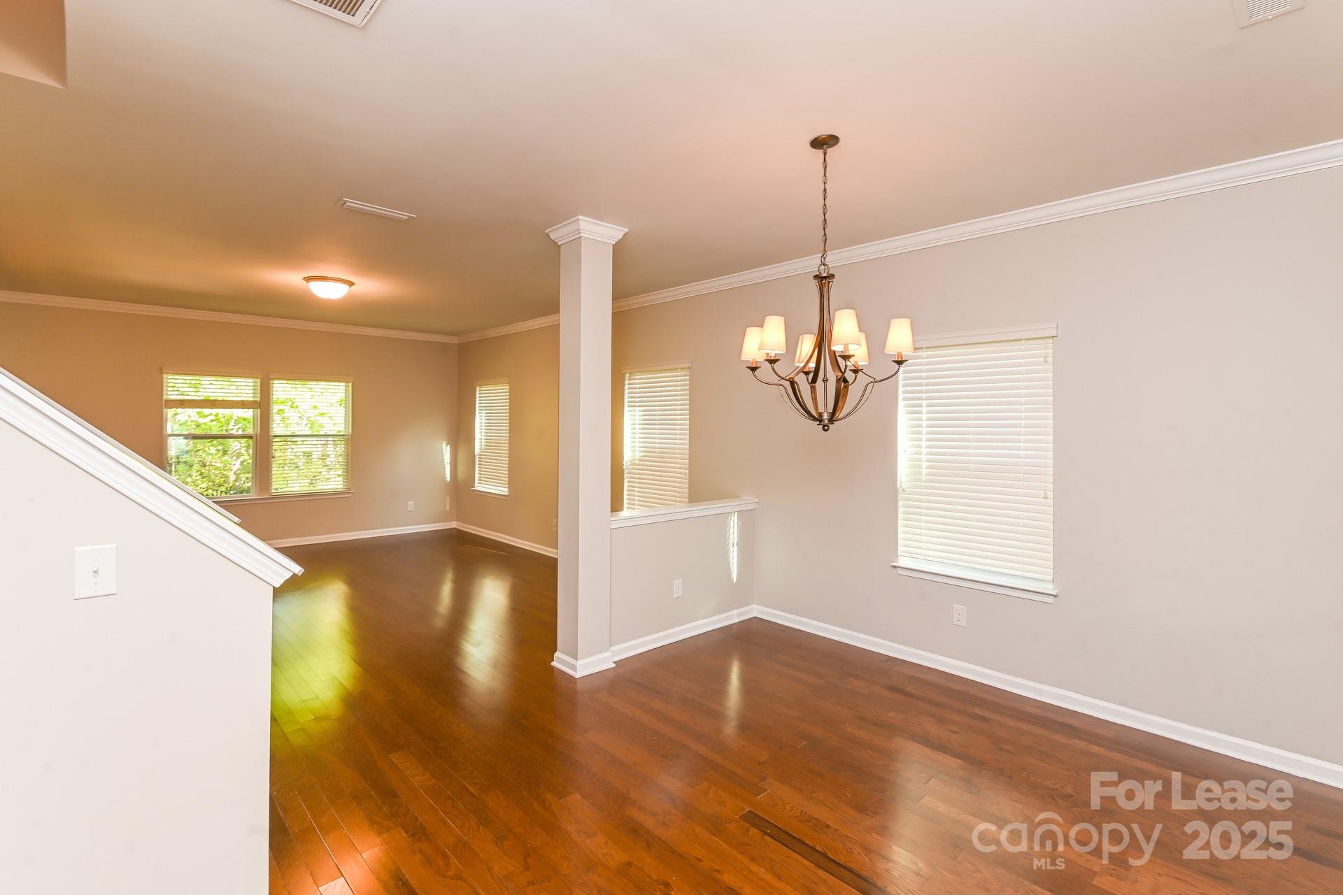 10813 Flintshire Road Mint Hill, NC 28227 - Photo 5 of 17 a view of a room with wooden floor chandelier and windows