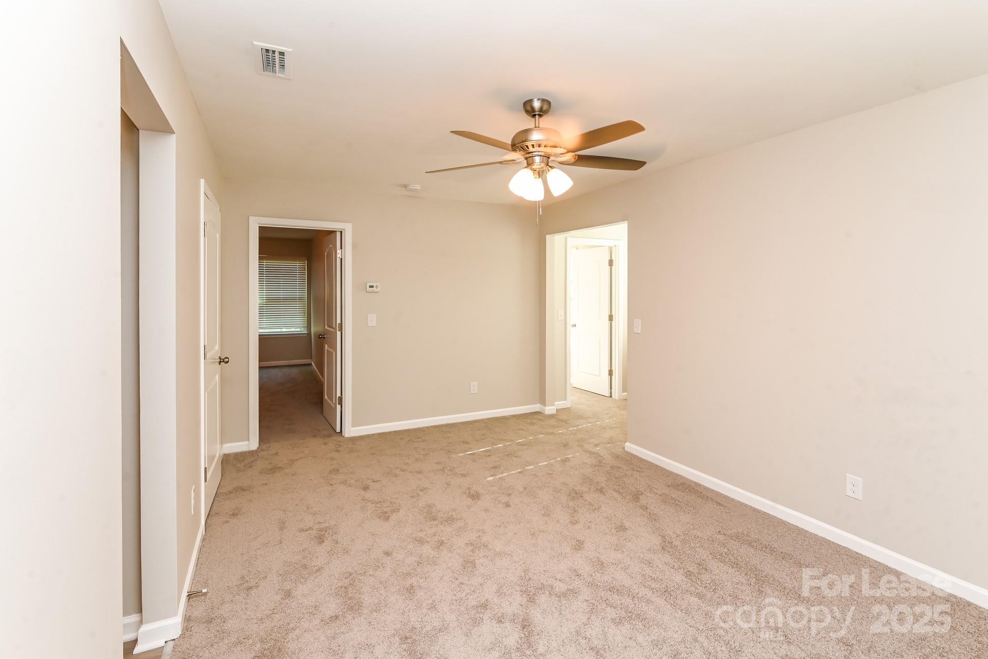 10813 Flintshire Road Mint Hill, NC 28227 - Photo 10 of 17 an empty room with a ceiling fan and a window