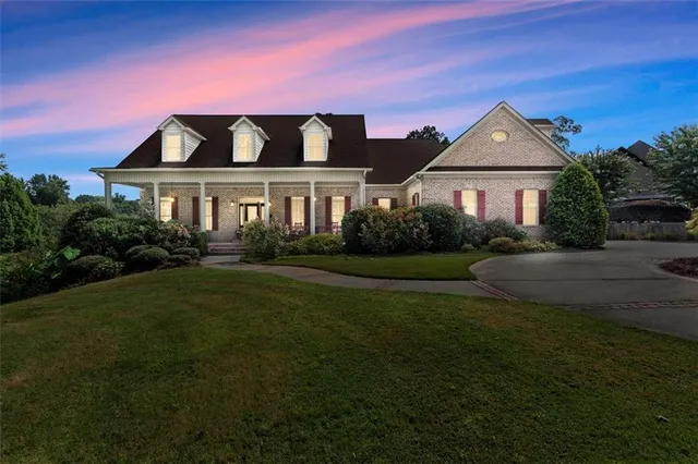 a front view of a house with a garden