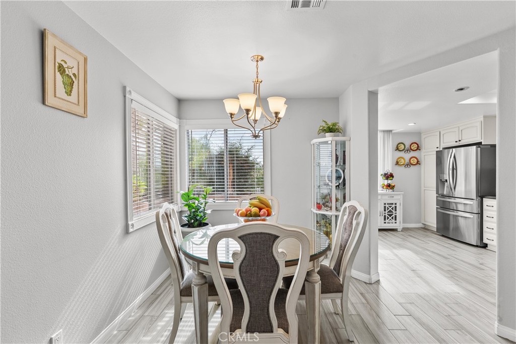 25726 Emerson Lane Stevenson Ranch, CA 91381 - Photo 11 of 45 a view of a dining room with furniture window and wooden floor