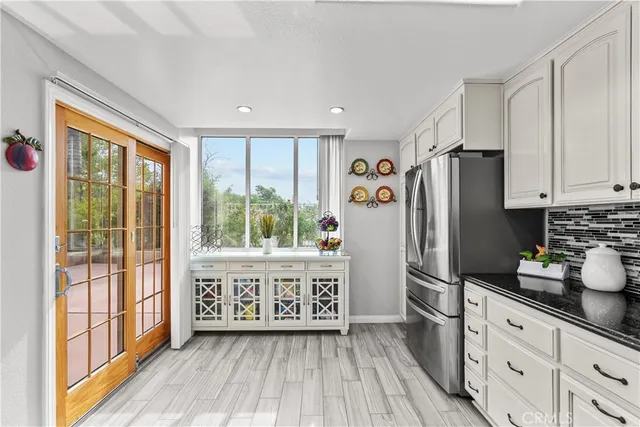 a kitchen with stainless steel appliances a refrigerator and wooden cabinets