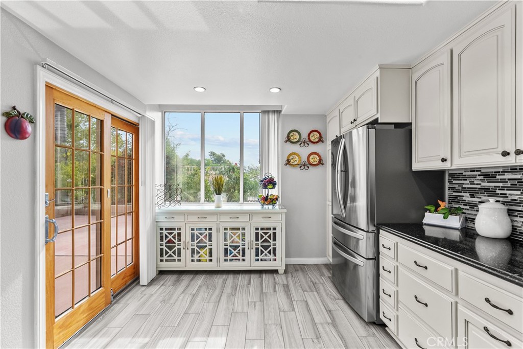 25726 Emerson Lane Stevenson Ranch, CA 91381 - Photo 13 of 45 a kitchen with stainless steel appliances a refrigerator and wooden cabinets