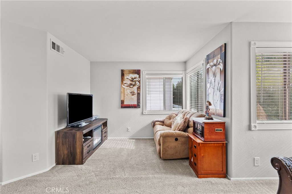 25726 Emerson Lane Stevenson Ranch, CA 91381 - Photo 24 of 45 a living room with furniture and a flat screen tv