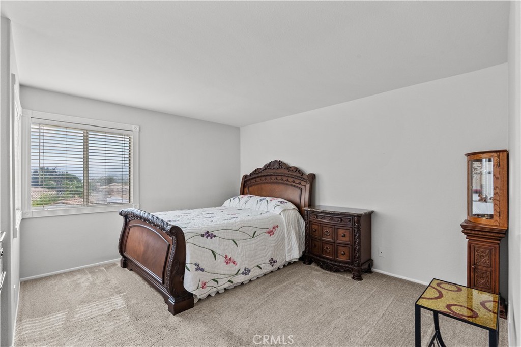 25726 Emerson Lane Stevenson Ranch, CA 91381 - Photo 25 of 45 a spacious bedroom with a bed and a window