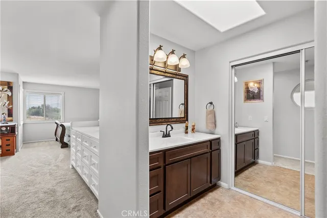 a bathroom with a sink vanity and a mirror