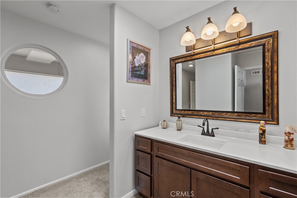 25726 Emerson Lane Stevenson Ranch, CA 91381 - Photo 28 of 45 a bathroom with a sink vanity and a mirror