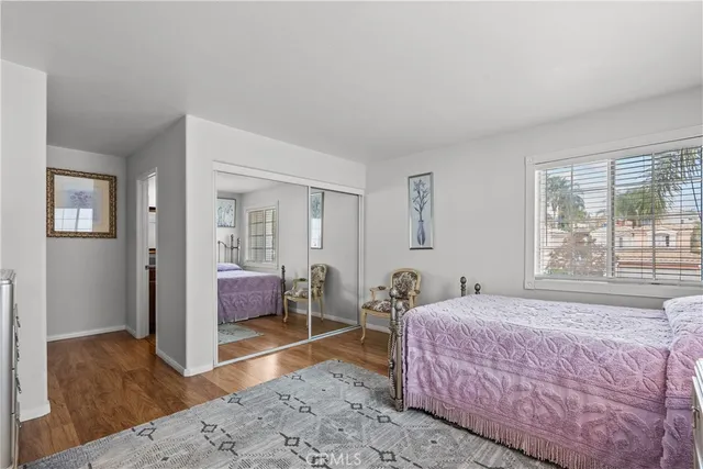 a bathroom with a granite countertop sink toilet a mirror and shower
