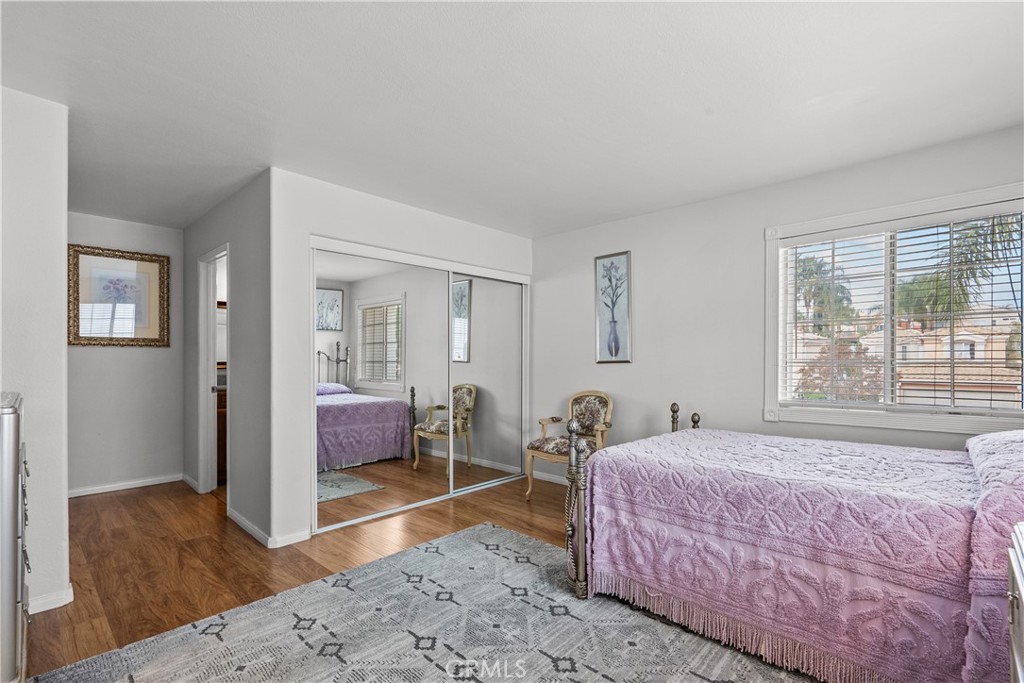 25726 Emerson Lane Stevenson Ranch, CA 91381 - Photo 33 of 45 a bedroom with a bed and wooden floor