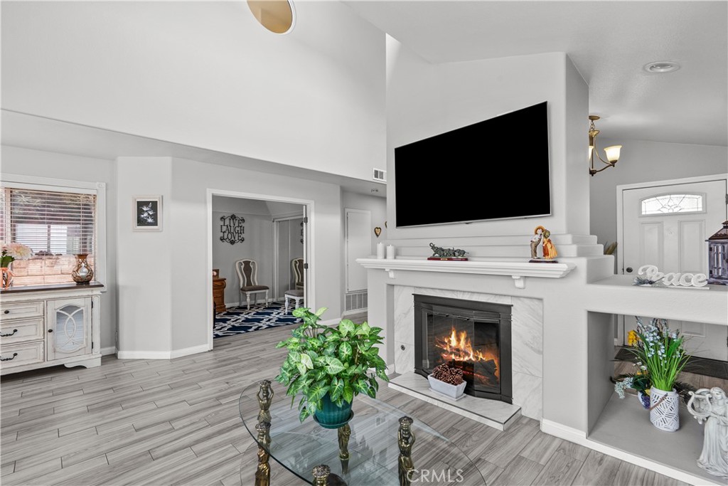 25726 Emerson Lane Stevenson Ranch, CA 91381 - Photo 8 of 45 a living room with furniture a fireplace and a flat screen tv