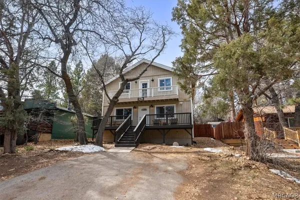 a view of a house with a yard covered in snow