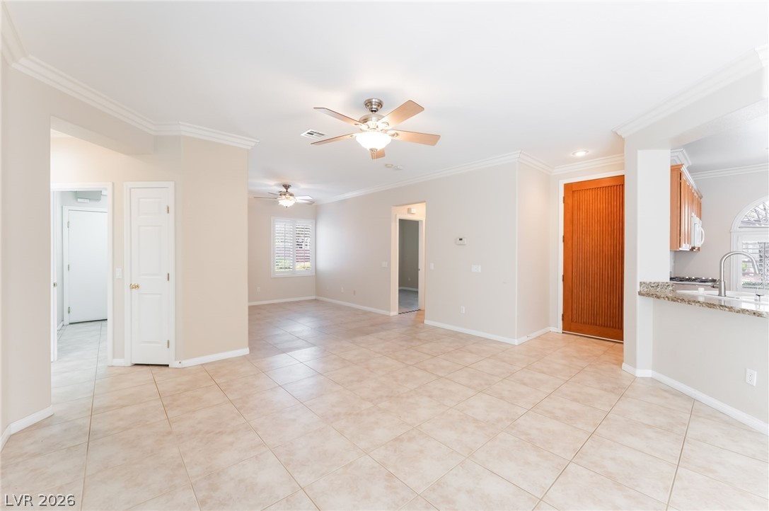 10481 Riverside Park Avenue Las Vegas, NV 89135 - Photo 9 of 51 Empty room with ornamental molding, ceiling fan, and light tile patterned floors