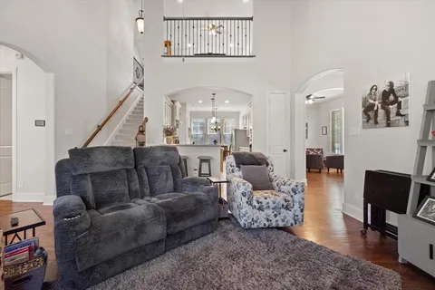 a living room with furniture and a mirror