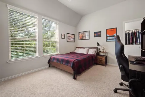 a bed room with a bed and a chair