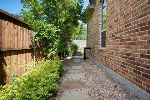 a pathway of a house with a yard