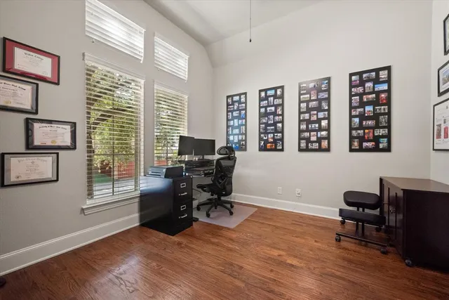 a view of a livingroom with workspace and a window
