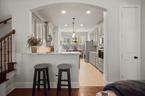 a kitchen with kitchen island granite countertop wooden floor and center island