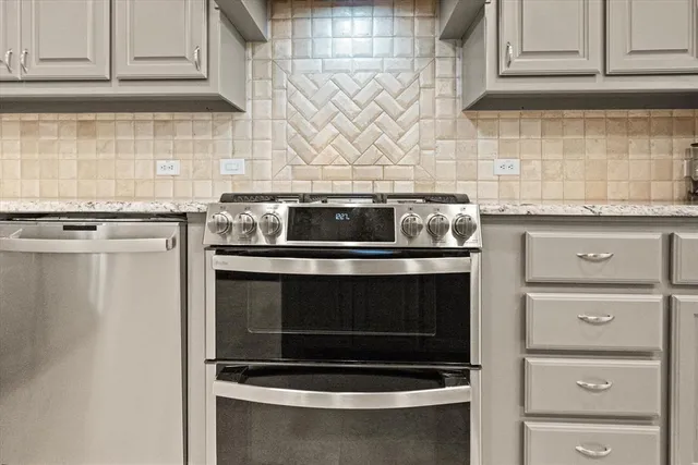 a stove top oven sitting inside of a kitchen and granite counter tops