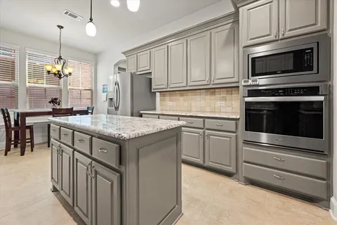 a kitchen with a sink stove and microwave
