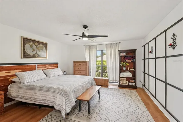 a bedroom with a large bed and a chandelier