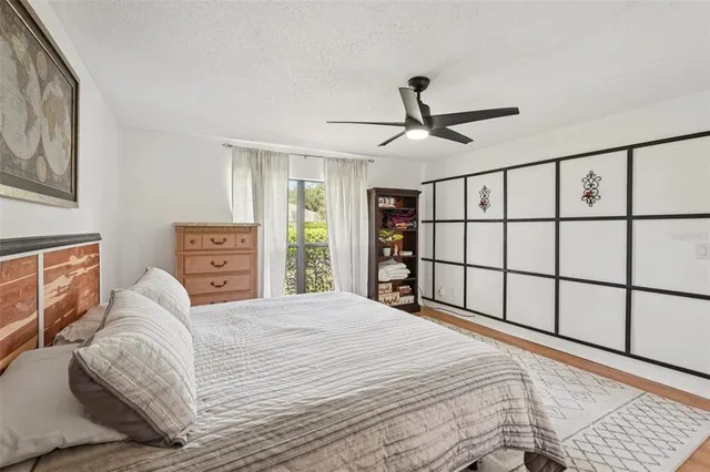 a bedroom with a large bed and a chandelier