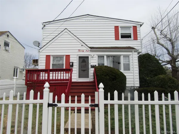 a view of a brick house with large windows