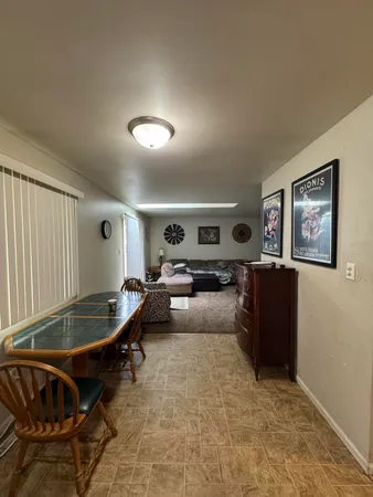 a living room with furniture gym equipment and a window
