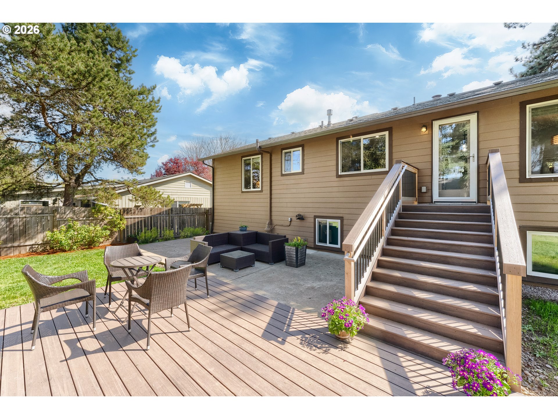 12785 Southwest Percheron Lane Beaverton, OR 97008 - Photo 13 of 42 a view of a patio with table and chairs with wooden floor and fence