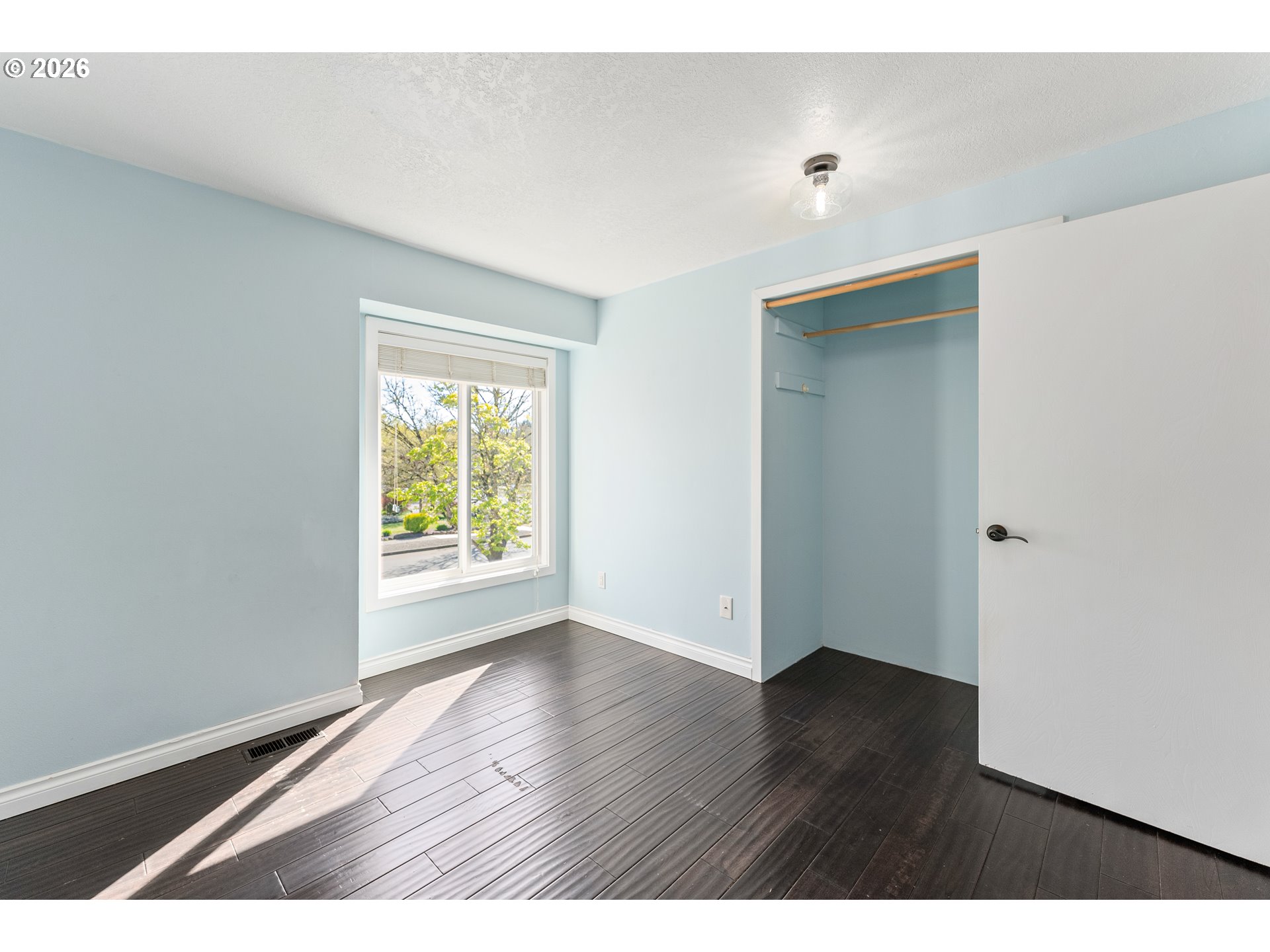 12785 Southwest Percheron Lane Beaverton, OR 97008 - Photo 23 of 42 a view of an empty room with wooden floor and a window