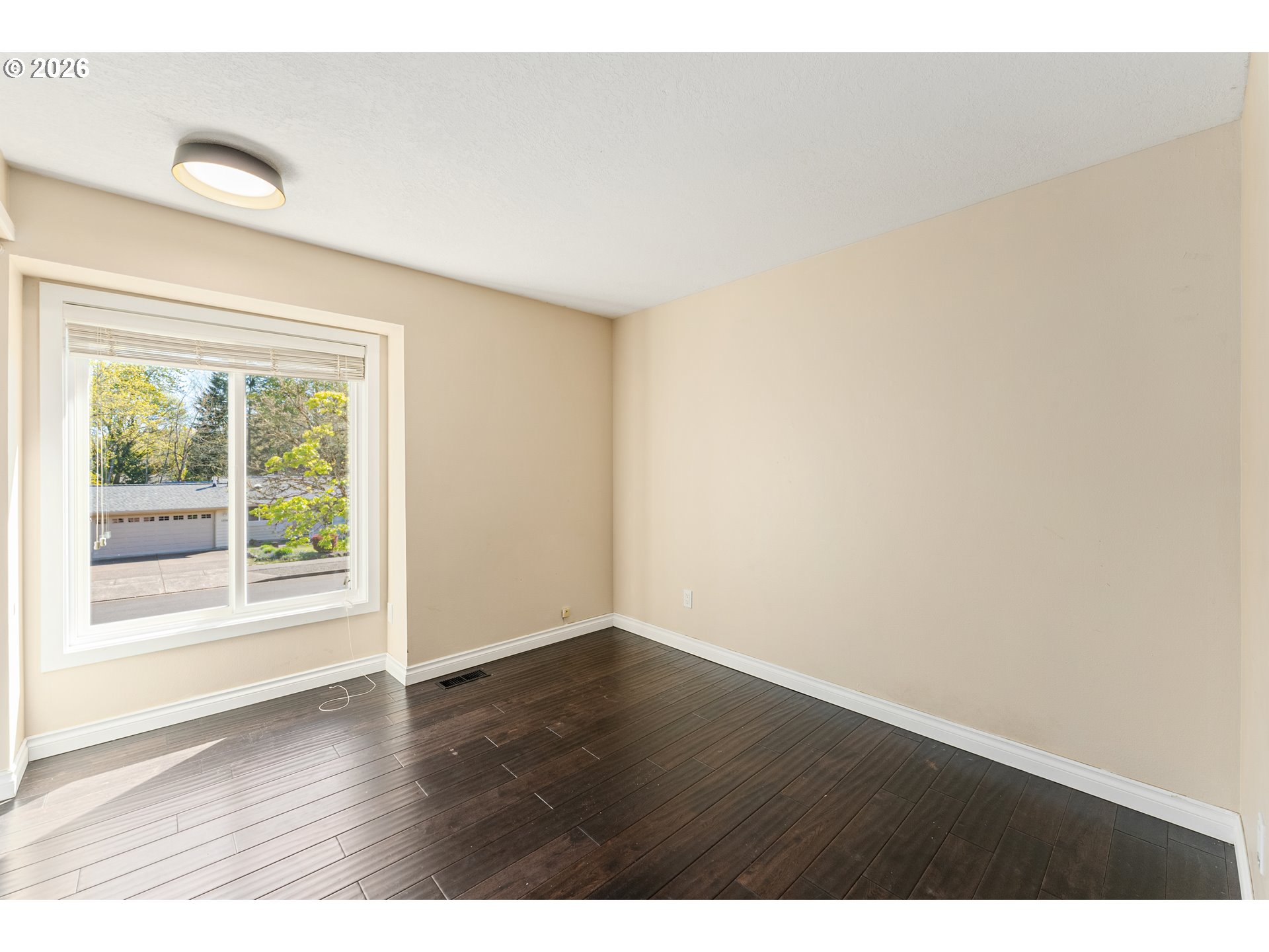12785 Southwest Percheron Lane Beaverton, OR 97008 - Photo 26 of 42 a view of an empty room with wooden floor and a window