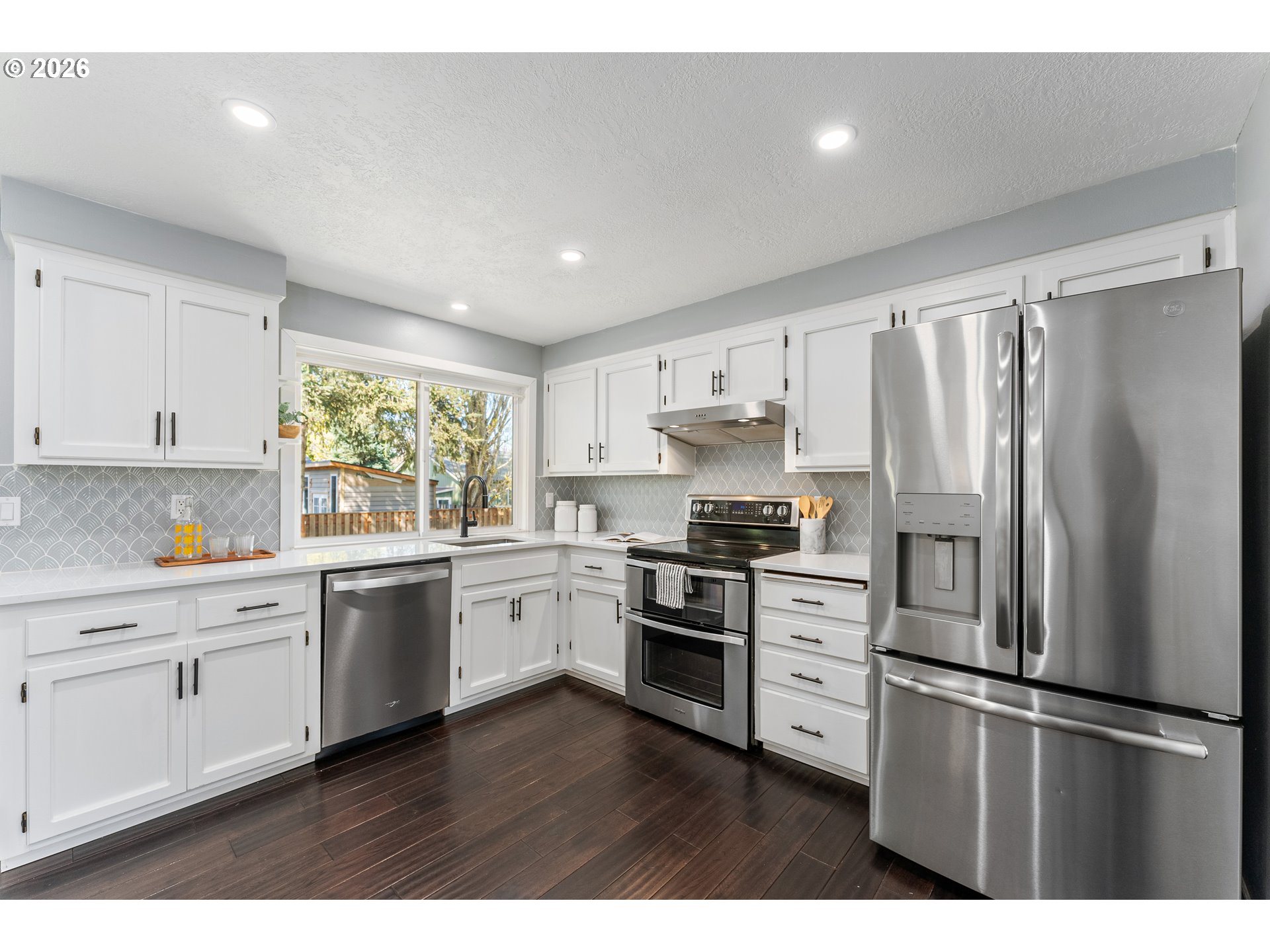 12785 Southwest Percheron Lane Beaverton, OR 97008 - Photo 5 of 42 a kitchen with stainless steel appliances a refrigerator sink and cabinets
