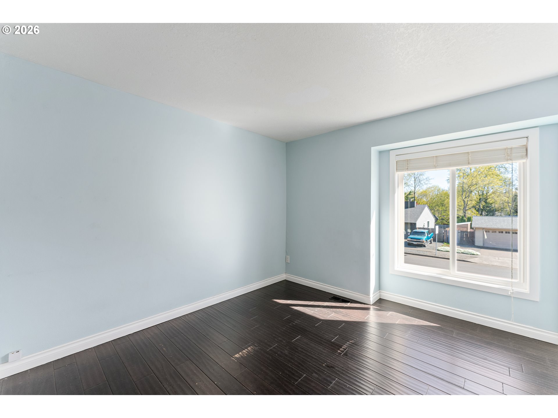 12785 Southwest Percheron Lane Beaverton, OR 97008 - Photo 8 of 42 an empty room with wooden floor and windows