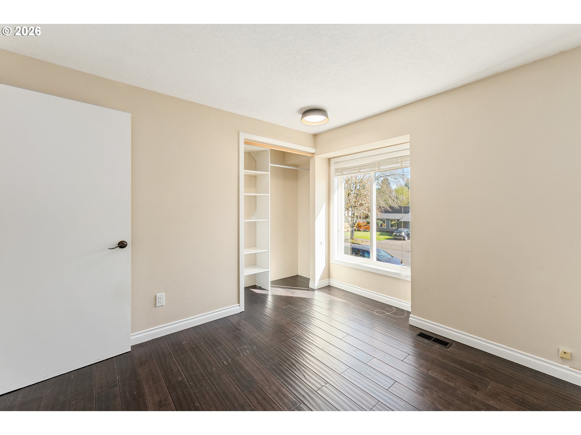12785 Southwest Percheron Lane Beaverton, OR 97008 - Photo 9 of 42 a view of an empty room with wooden floor and a window